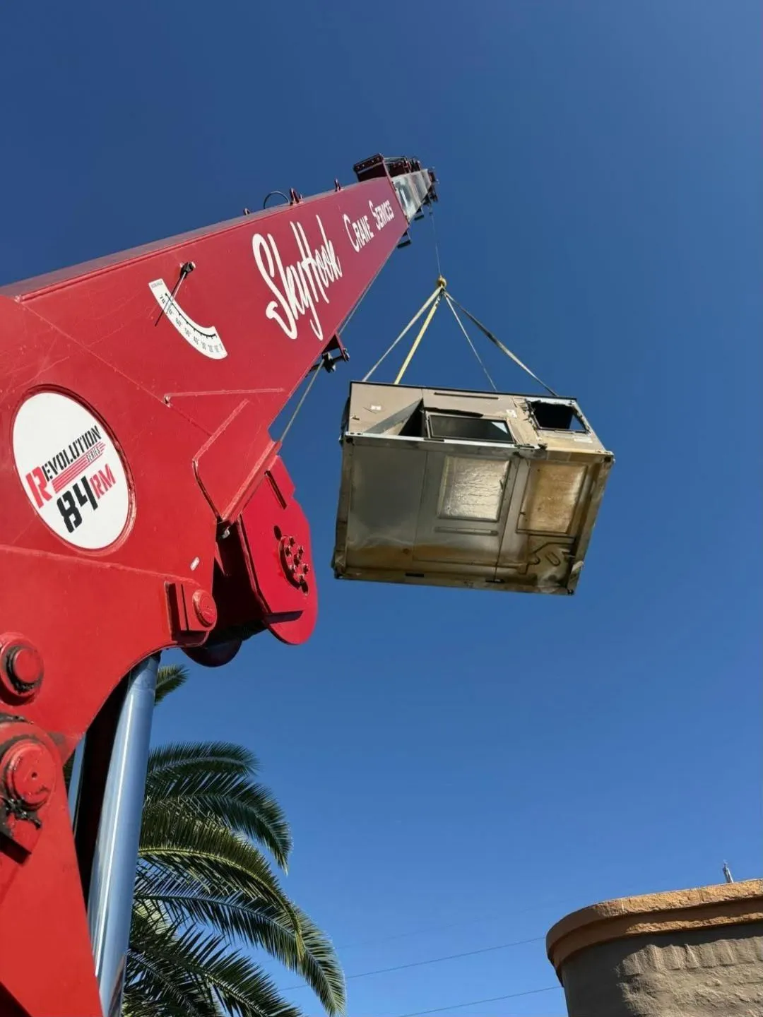 Rooftop HVAC unit rigged and lifted by the Skyhook crane boom