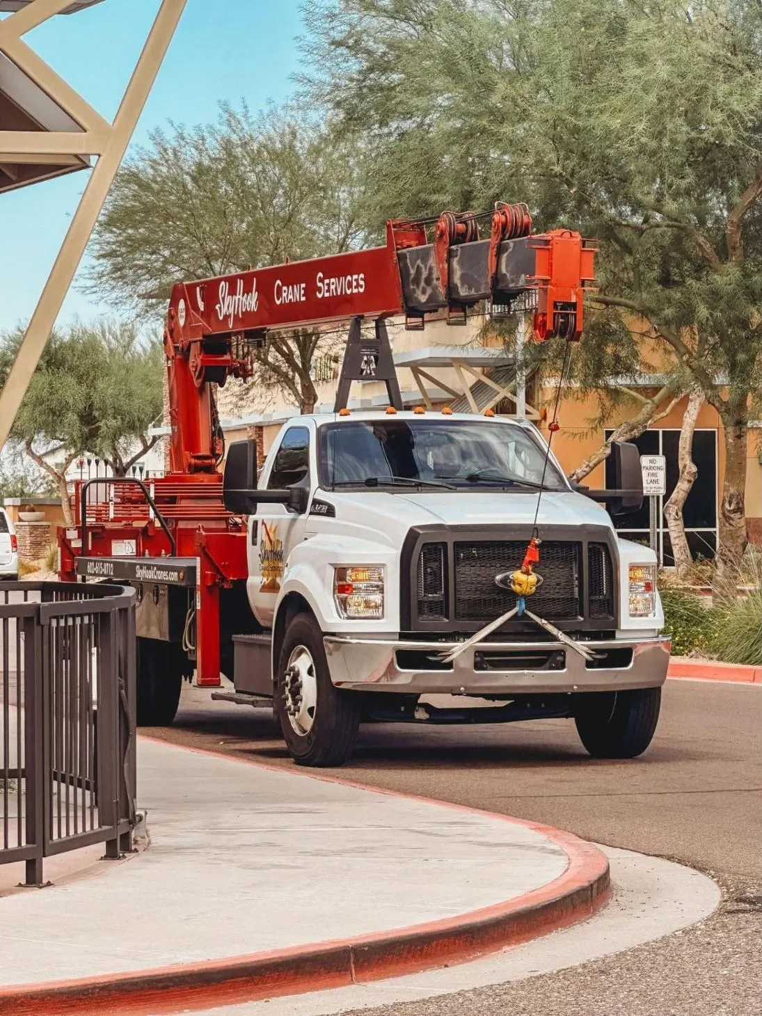 Skyhook Crane white Ford boom truck with red telescopic crane